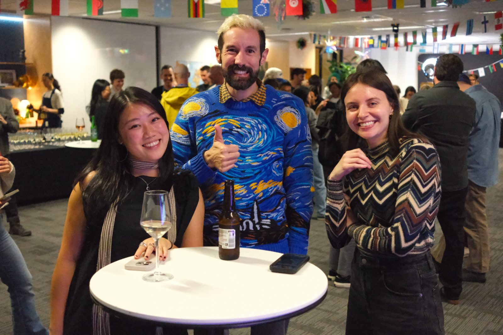 Three people cheersing drinks